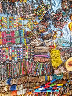 many different bracelets and necklaces are on display