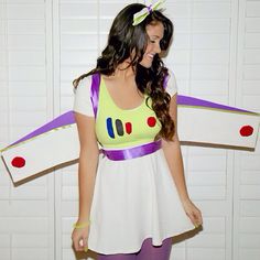 a woman in a costume is standing with her arms spread out to show the shape of an airplane