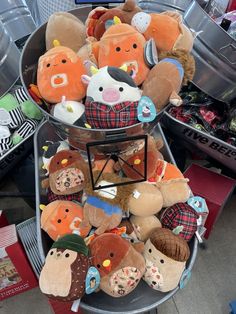 a pile of stuffed animals sitting on top of a metal tray next to other items