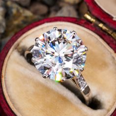 a diamond ring sitting on top of a wooden box