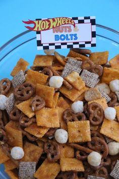 a bowl filled with cereal and marshmallows on top of a blue table