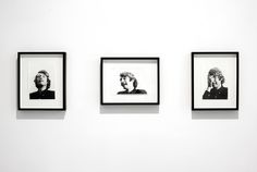 three black and white photographs hanging on the wall