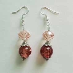 "\"PRISTINE PINK\" earrings These pretty pink earrings are made up of pale pink faceted glass beads, vintage round pink acrylic beads, silver etched metal beads, and silver seed beads. Approximate Measurements: Earring Length - 2.25 inches Earring Drop Length - 1.5 inches Earring Width - .5 inch *These earrings arrive in a handmade, hand-decorated box." Pink Dangle Jewelry With Faceted Beads, Handmade Pink Crystal Earrings In Sterling Silver, Handmade Pink Crystal Sterling Silver Earrings, Nickel-free Pink Beaded Earrings, Pink Round Beaded Earrings With Dangling Beads, Nickel-free Pink Round Beaded Jewelry, Pink Beaded Drop Crystal Earrings, Pink Beaded Crystal Drop Earrings, Glass Earrings With Faceted Beads For Gift