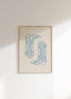 a blue and white drawing hanging on the wall