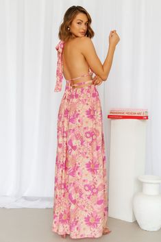 Length from bust to hem of size S: 130cm. Floral print maxi dress. Non-lined. Cold hand wash only. Model is a standard S and is wearing S.鈥/li>True to size. Non-stretchy and midweight fabric. Print placement may vary. Polyester. Experience true freedom in this piece, we guarantee you'll have No Cares at all! Featuring a long and flowy skirt with a silt and a tie-up halterneck as well as back ties. Style yours with sandals and waves. Pink Flowy Maxi Dress With Tie Back, Pink Maxi Sundress With Tie Back, Pink Printed Maxi Dress For Garden Party, Pink Summer Maxi Dress With Tie Back, Pink Tie Back Maxi Dress For Summer, Flowy Pink Printed Maxi Dress, Bohemian Pink Maxi Dress With Tie Back, Pink Printed Floor-length Maxi Dress, Pink Maxi Dress For Dress Down Occasions