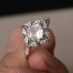 This is a gorgeous handmade creation. Its beauty is its simplicity & Elegance. The 7*7 mm cushion shape faceted natural pink quartz is crafted in solid sterling silver and with rhodium plated. All item is sent in a beautiful gift box If you have any idea of design your ring,pls contact me directly. You can realize more lovely stuff clicking the link https://www.etsy.com/shop/knightjewelry?refshopsection_shophome_leftnav Please leave the correct address and you phone number for delivering suc Pink Cushion Cut Morganite Jewelry, Cushion Cut Morganite Jewelry With Center Stone, Cushion Cut Rose Cut Diamond Jewelry For Promise Ring, Rose Cut Diamond Cushion Cut Ring Gift, Elegant Pink Moonstone Sterling Silver Ring, Cushion Cut Rose Diamond Ring Gift, Wedding Crystal Ring With Rose Quartz Gemstone, Elegant Pink Moonstone Ring For Anniversary, Elegant Rose Quartz Rings For Anniversary