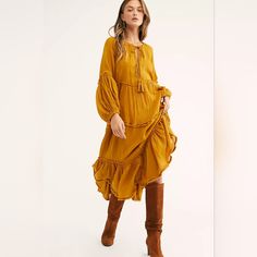 Free People In The Moment Midi Dress In Golden Glow, Sz M. Dress Is Tiered With Raw Hems/Seams & Balloon Sleeves. Knit Accent Trim Along Sleeves & Deep V Neckline With Tassle Ties Plus Loop & Button Closure. Oversized - Will Easily Work For A Size L. Measures Approx 26" Across Underarms & About 48" Length. Fabrication: 100% Rayon With 100% Cotton Contrast. Good Preowned Condition With A Bit Of Fraying Along The Raw Seams & One Small Spot On The Bodice (Pictured). Yellow Long Sleeve Maxi Dress With Ruffles, Yellow Ruffled Long Sleeve Maxi Dress, Yellow Long Sleeve Ruffled Maxi Dress, Yellow Midi Dress With Ruffles For Fall, Fall Yellow Midi Dress With Ruffles, Yellow Ruffled Midi Dress For Fall, Bohemian Yellow Midi Dress With Ruffles, Yellow Bohemian Knee-length Midi Dress, Yellow Bohemian Maxi Dress For Fall