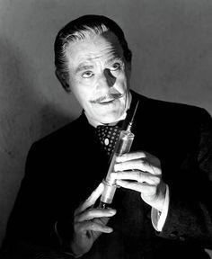 black and white photograph of a man holding a syringe in his right hand