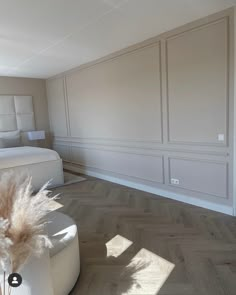 an empty bedroom with white walls and wood flooring