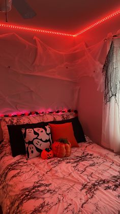 a bed with halloween decorations and lights on the headboard