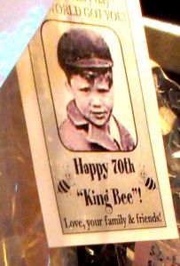 a sign that says happy 70th king bee with an image of a young boy on it