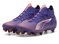 a pair of purple and orange soccer shoes