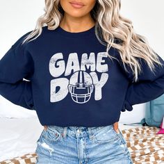 Perfect for any football fan! Show your team spirit with this awesome sweatshirt! Unisex 50/50 Cotton & Polyester Blend.  Fit: All shirts are unisex fit, true to size, loose fit. Recommend going up 1-2 sizes for an oversized look. Please check the size chart. If you have any questions, please contact us. Please check your address to make sure it is your current address. Care Instructions:  For the best and lasting results, wash in cold water inside out. No bleach. Dry on low heat or hang dry. Do not iron over design.  Returns: Because this item is made to order, all sales are final. No returns are accepted.  Please let us know if you have a problem with your order and we will try to correct the issue.  Shipping: Orders usually ship within 3 business days. Please allow approximately 5 days Team-colored Sweatshirt For Football Season, Team-colored Football Season Sweatshirt, Long Sleeve Sports Fan T-shirt, Football Season Fan Gear Sweatshirt With Graphic Print, Collegiate Sweatshirt With Team Logo For Football Season, Team-colored Varsity Sweatshirt For Football Season, Collegiate Style Sweatshirt With Team Logo For Football Season, Collegiate Football Season Sweatshirt With Team Name, Collegiate Football Season Sweatshirt