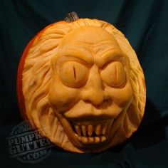 a pumpkin carved to look like an old man's face with his mouth open