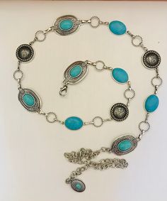 This is a beautiful handmade piece of body jewelry. Man made Silver oval  Conchos will turquoise color stone inside and smaller oval Conchos with turquoise colored stone.  The round man made silver Concho has rope edge. This chain belt has  Lobster clasp and small oval Concho at end of extension chain. Large Concho is 1-1/2" oval, smaller oval is 1" long and and  Round Concho size is 1" This is a Unique style sure to be one of a kind. Comes in 1 size which are measured end to end of Conchos and Bohemian Adjustable Chain Belt As A Gift, Western Blue Jewelry For The Beach, Bohemian Oval Jewelry With Adjustable Chain, Bohemian Style Adjustable Chain Belt, Southwestern Style Silver Jewelry For The Beach, Turquoise Cowgirl, Boho Turquoise, Turquoise Boho, Colored Stone