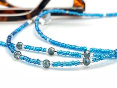 Dainty and bohemian eyeglass necklace chain in blue/Turquoise tones, made with Preciosa Czech crystal seed beads tiny silver plated crystal seed beads and delicate light blue cubic zirconia crystal beads. Paired with grey blue cubic zirconia crystal beads, this handmade eyeglass chain will definitely create a unique look.  The eyeglass lanyard is made on strong quality beading wire with silver plated wire guardians that protect the quality eyeglass holder grips. The necklace is ended with spring Glasses Cord, Beaded Eyeglass Chain, Sunglasses Necklace, Crystal Sunglasses, Eyeglass Necklace, Glasses Chains, Eyeglass Chain, Eyeglass Holder, Grandma Gift