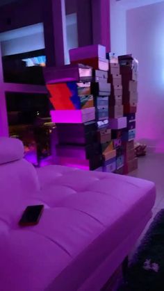 there is a bed that has been made out of cardboard boxes in the room with purple lighting