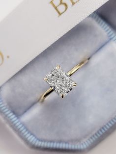 This astonishing stand alone style ring has a 1.52 carat lab grown radiant cut center diamond and is IGI certified at "F" in color and "VVS2" in clarity, (Excellent Cut, Polish and Symmetry) and is set in a classy solitaire plain razor thin setting in 14K yellow gold. The ring can also be made in white/rose gold or platinum and can even be redesigned to your choice. Comes with IGI certification and our lifetime warranty as well. Wedding Ring Gold Band Rectangle Diamond, Wedding Rings Gold Square, Classy Engagement Ring Square, Gold Band Princess Cut Engagement Ring, Engagement Rings Radiant Cut Gold, Radiant Engagement Ring 1 Carat, Lab Grown Radiant Cut Engagement Ring, 1 5 Carat Radiant Engagement Ring, Radiant Wedding Ring Set Gold