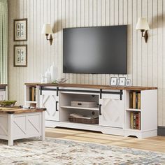 a living room scene with focus on the entertainment center and large screen tv mounted to the wall