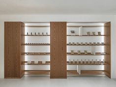 an empty room with wooden shelves filled with items