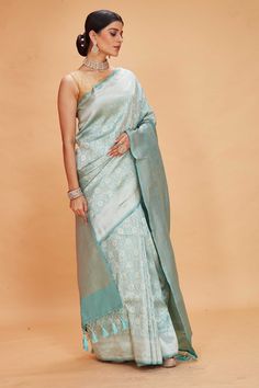 Look your ethnic best at weddings and special occasions in this pastel green Katan Banarasi saree. It is adorned with floral zari jaal. The saree comes with a matching blouse piece. Disclaimer: The shown stitched blouse on the model is for display purpose only. The saree comes with a matching blouse piece and finished with fall and piko. Tussar Silk Sarees, Indian Clothing Store, Fashion Journals, Tussar Silk Saree, Banarasi Saree, Indian Clothing, Traditional Fabric, Saree Online, Banarasi Sarees