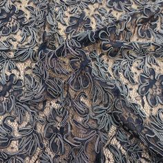 an image of a black lace fabric with floral design on it's edges and bottom