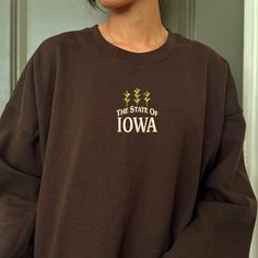 This vintage inspired crewneck features an embroidered design of Iowa and corns! This embroidered crewneck is super cozy to wear out or lounge at home. ⭐  Product Details * Unisex Sizing * 50% cotton, 50% cotton * Embroidery will come with a backing material. This is the stabilizer and is necessary to support stitching. * Gildan 18000 Unisex Heavyblend Sweatshirt * Size up 1-2 sizes for a looser comfy fit ⭐  Care Instructions Wash with cold water. Hang drying is recommended but dry low if needed Custom Embroidery Crew Hoodie For Fall, Brown Sweatshirt With Embroidered Logo For Fall, Fall Custom Embroidery Crew Hoodie, Brown Fall Sweatshirt With Embroidered Logo, Fall Embroidered Crew Hoodie, Brown Cotton Sweatshirt With Embroidered Logo, Brown Long Sleeve Sweatshirt With Embroidered Logo, Embroidered Crewneck, Sweatshirt Vintage