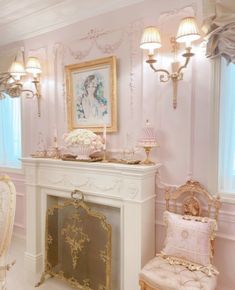 a fancy living room with pink walls and gold furniture, including a fireplace mantel