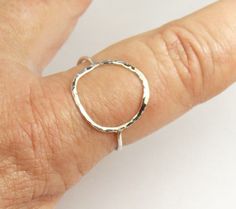 A hammered circle ring made with 18 gauge wire. Modern and simple minimal jewelry. Made with sterling silver Handmade and polished to a high shine in my shop. The circle symbol meaning is universal, sacred and divine. It represents the infinite nature of energy, and the inclusivity of the universe. Purity ring, karma ring, midi ring modern and simple Moisture in the air or on the skin can react with the %7 copper present in all Sterling Silver jewelry, causing a green discoloration. size 4-13 1/ Hammered Sterling Silver Midi Rings, Minimalist Hammered Sterling Silver Midi Rings, Silver Hammered Midi Rings, Hand Forged Sterling Silver Stackable Rings, Karma Ring, Circle Symbol, Purity Ring, Midi Ring, Circle Ring