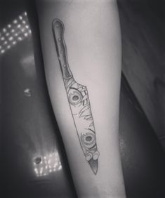 a black and white photo of a knife on the leg