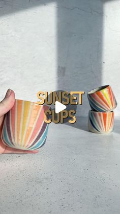 a hand holding a cup with the words sunset cups in front of it and three other bowls