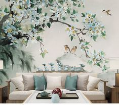 a living room with flowers and birds painted on the wall