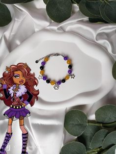 Embody Clawdeen's fierce elegance and bold style with this uniquely handcrafted bracelet 🌕. Designed to capture the power and wild charm of this Monster High icon, each bead and charm has been carefully chosen and hand-assembled to reflect his bold spirit and fashionable look 🖤💜. Inspiration: Clawdeen, the werewolf's daughter, is known for her bold style and strong personality. This bracelet captures its wild essence and unique charm, bringing a touch of fierceness and glamor to the wearer 🐺 Monster High Bracelet, Monster High Icon, Wolf Monster, Monster High Clawdeen Wolf, Monster High Clawdeen, Wolf Bracelet, Clawdeen Wolf, Bracelet Inspiration, Strong Personality