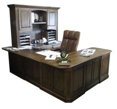 an office desk with a chair and cabinets