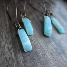 Like waters deep and ancient, Amazonite beckons in captivating shades of turquoise-green, promising to soothe the spirit and calm the soul. Its energy is as powerful as the river for which it is named, and as bold as the legendary women warriors with whom it is connected. Harness your inner goddess in a pair of these today! ★ Hand selected all natural raw amazonite gemstones ★ Ready to ship in 1-2 days ★ Crystals range 20-25mm long ★ These hang approx. 2.5" ★ Aged brass kidney ear wires ★ Crysta Turquoise Jade Earrings With Natural Stones, Green Spiritual Earrings For Healing, Blue Jade Jewelry For Meditation, Bohemian Amazonite Earrings For Gifts, Bohemian Amazonite Earrings As Gift, Turquoise Dangle Earrings With Amazonite, Turquoise Amazonite Dangle Earrings, Spiritual Turquoise Earrings With Natural Stones, Turquoise Amazonite Earrings For Gift