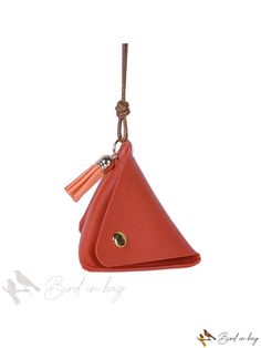 a small red purse hanging from a cord