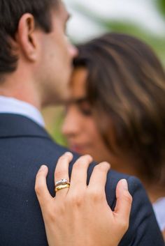 a close up of a person wearing a wedding ring