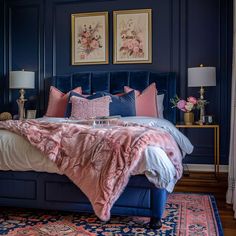 a bedroom with blue walls and pink bedding