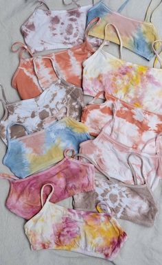 tie dye bras laid out on a bed