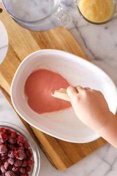 a child is mixing ingredients in a bowl