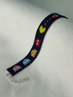 a bracelet made out of beads with video games on it