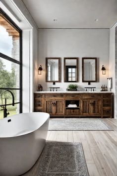 a large white bath tub sitting under two mirrors next to a wooden vanity and double sinks