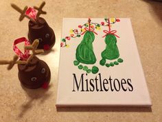 two chocolate covered candies sitting on top of a table next to a sign that says mistletoes