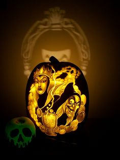 a carved pumpkin sitting next to a skull and a green apple with a shadow on it