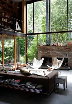 a living room filled with furniture and large windows