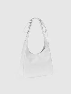 ALKI ALKA, short for Architecture Archive, incorporates the structural design of objects into its creations, adhering to the modernist philosophy of Less Is More. - Softly curved upper silhouette- Made of smooth and glossy leather- Long ribbon drop embellished shoulder strap- Hidden magnetic closure at the opening- Zipper pocket at the interior Modern White Shoulder Bag With Adjustable Strap, White Structured Bag For Everyday Use, White Structured Shoulder Bag For Everyday Use, White Structured Everyday Bag, White Structured Formal Bag, Modern White Shoulder Bag For Shopping, Modern White Shoulder Bag, White Minimalist Shoulder Bag With Adjustable Strap, Minimalist White Shoulder Bag With Adjustable Strap