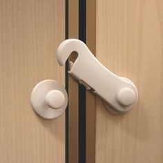 a white door handle on a wooden door