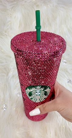 a hand holding a starbucks cup covered in sequins