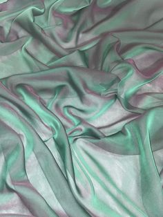 the fabric is very soft and shiny with some green highlights on it's surface