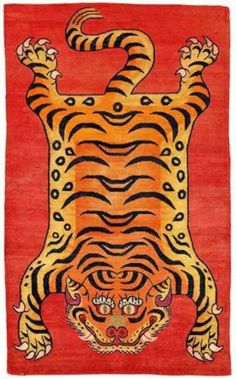 an orange rug with a tiger on it's face and two eyes in the middle